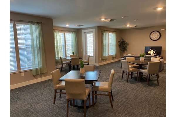 A dining room with a table set for six.